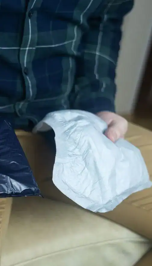 Image of man holding incontinence pads as part of overactive bladder treatment Middlesbrough